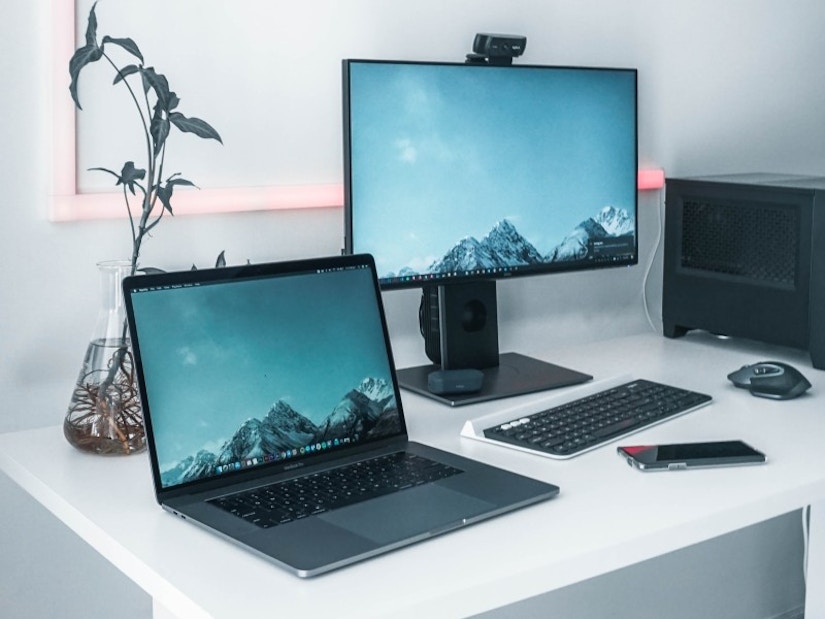 Arbeitsplatz mit Monitor, Laptop und Tastatur